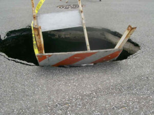 A common result of leaking manhole connectors is sink holes.