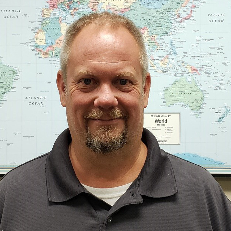 Profile pic of a man in a gray shirt with a map in the background