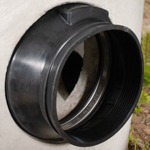 Black rubber manhole boot in concrete structure