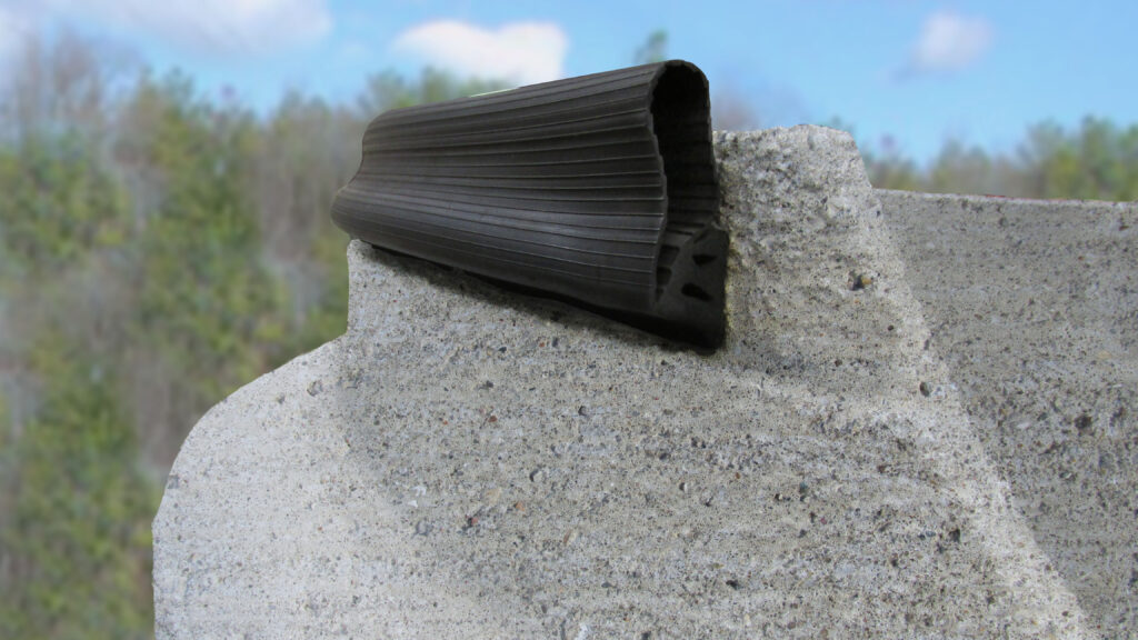 RFS gasket profile resting along the top of a concrete manhole frame.