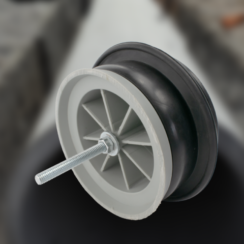 black rubber connector assembled on a gray plastic mandrel with a bolt in middle